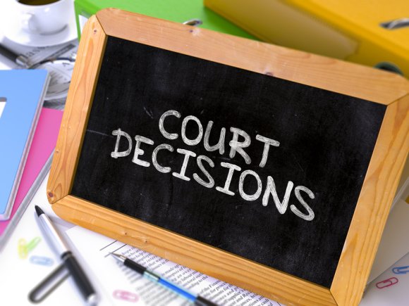 "Court decisions" written on a Wooden slate