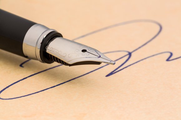 A pen and paper with signature on it