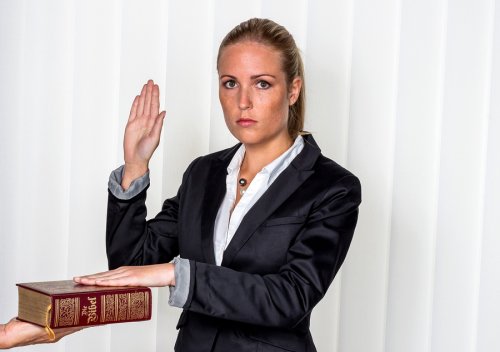 A girl taking pledge by keeping hand on book