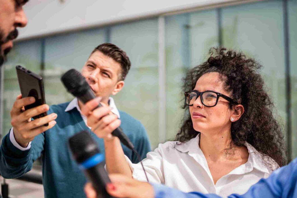 Reporters Holding Microphones During an Outdoor Interview in San Jose, CA